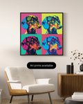 A framed pop-art style dachshund print hangs on a light beige wall above a white armchair and a wooden sideboard. The artwork shows four colorful quadrants with a dachshund portrait in bright neon tones.