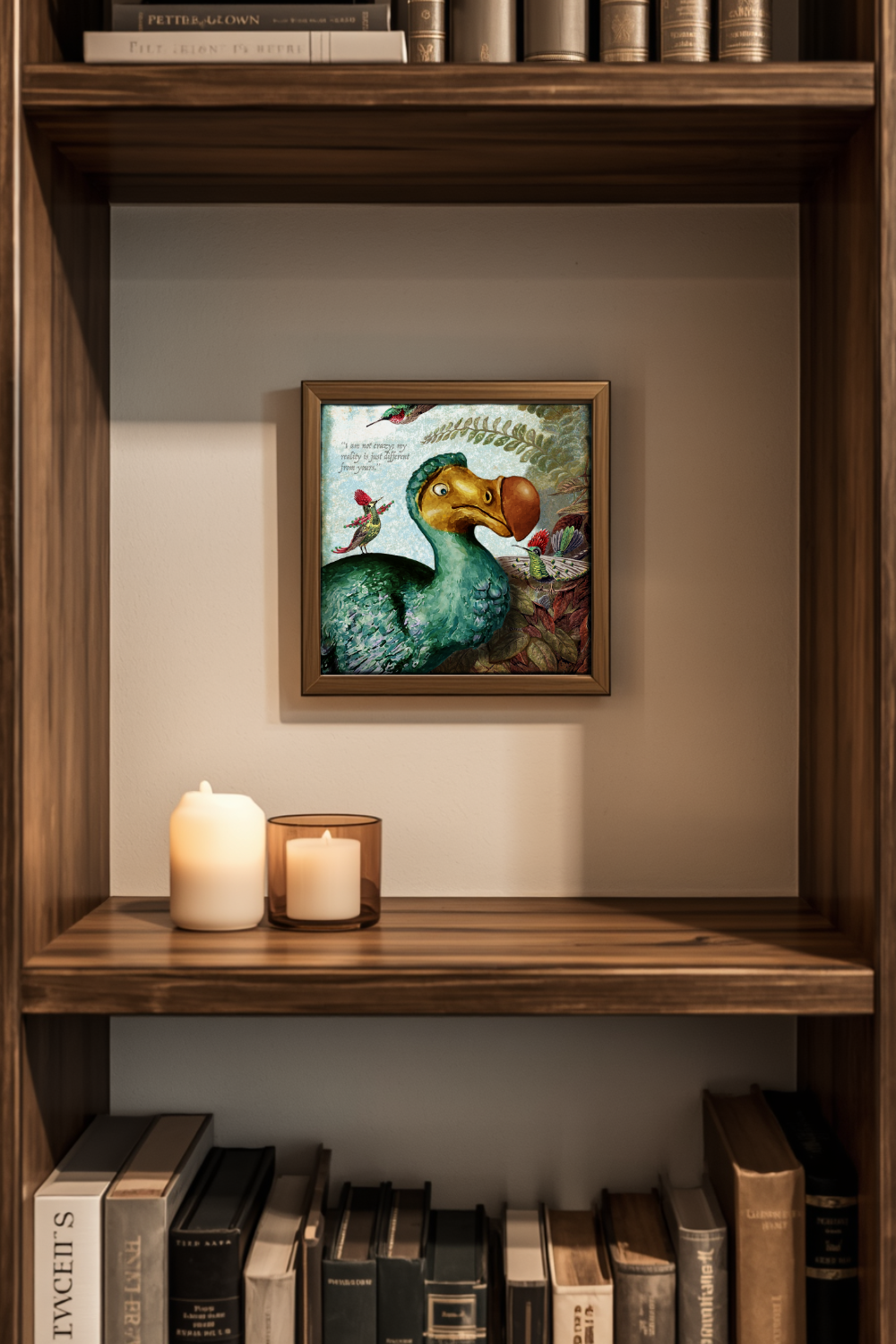 A framed art print of a Dodo bird hanging on a beige wall inside a wooden bookshelf, styled with two white pillar candles and books.