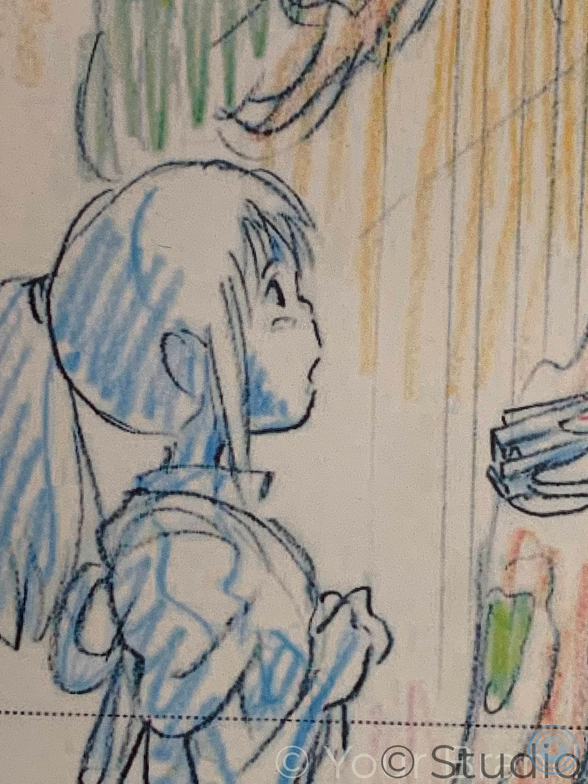A close-up of a colored pencil sketch on paper, showing a side profile of a character with blue hair and a blue outfit, alongside yellow and green pencil strokes. Spirited Away print