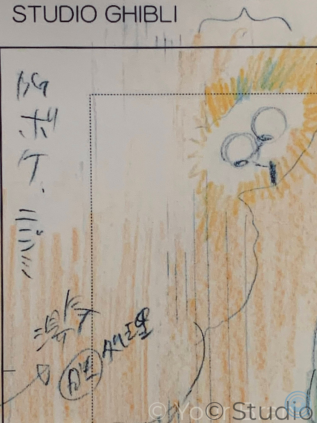 A close-up of a hand-drawn art print or sketch on a light background, featuring a stylized face with circular eyes and yellow/orange scribbled shading, with the text 'STUDIO GHIBLI' at the top and a watermark at the bottom.