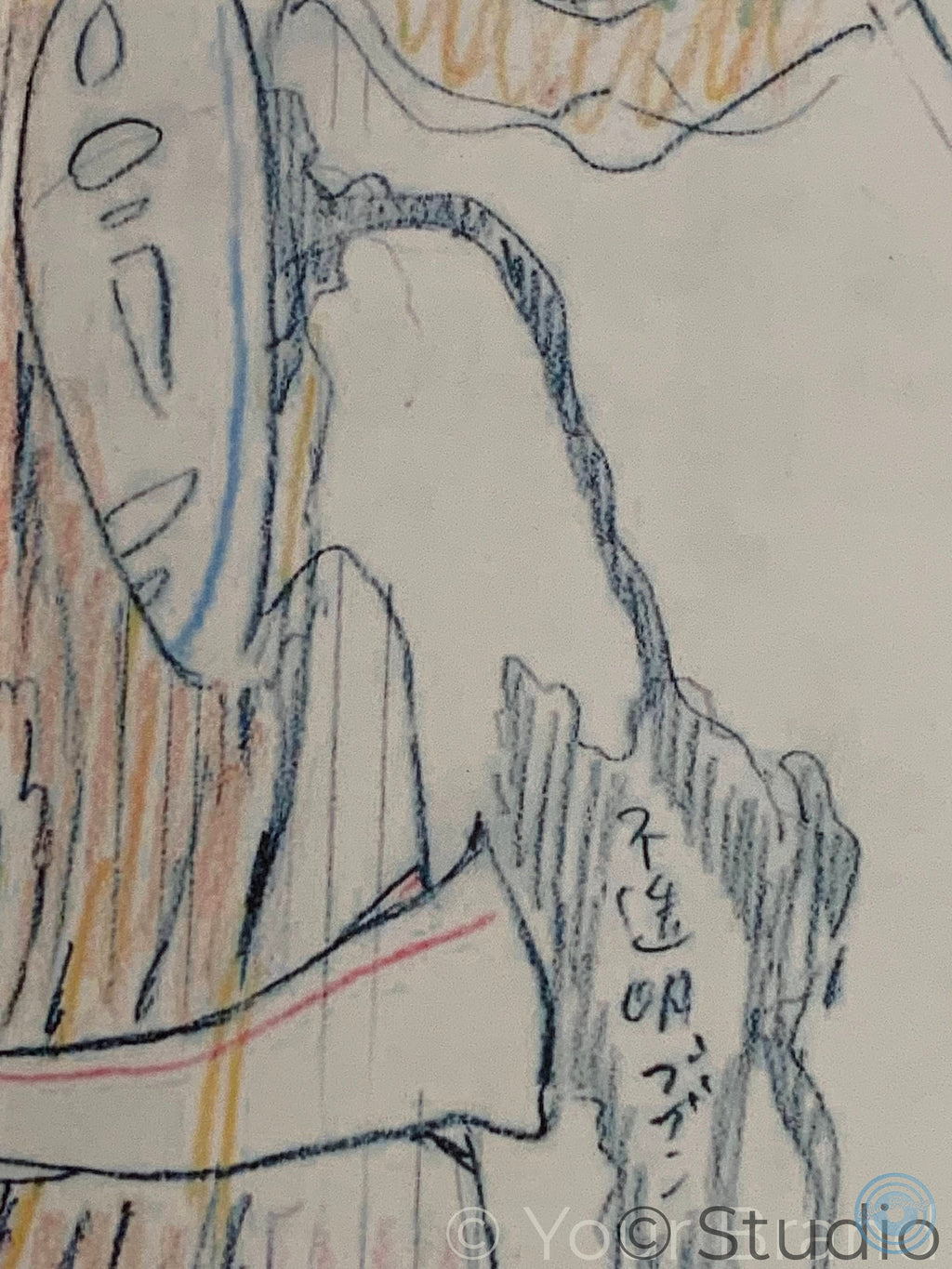 A close-up of a coloured pencil drawing on textured paper, showing a figure in profile with blue, orange, and black sketch lines and Japanese characters written on a rock. Spirited Away movie poster
