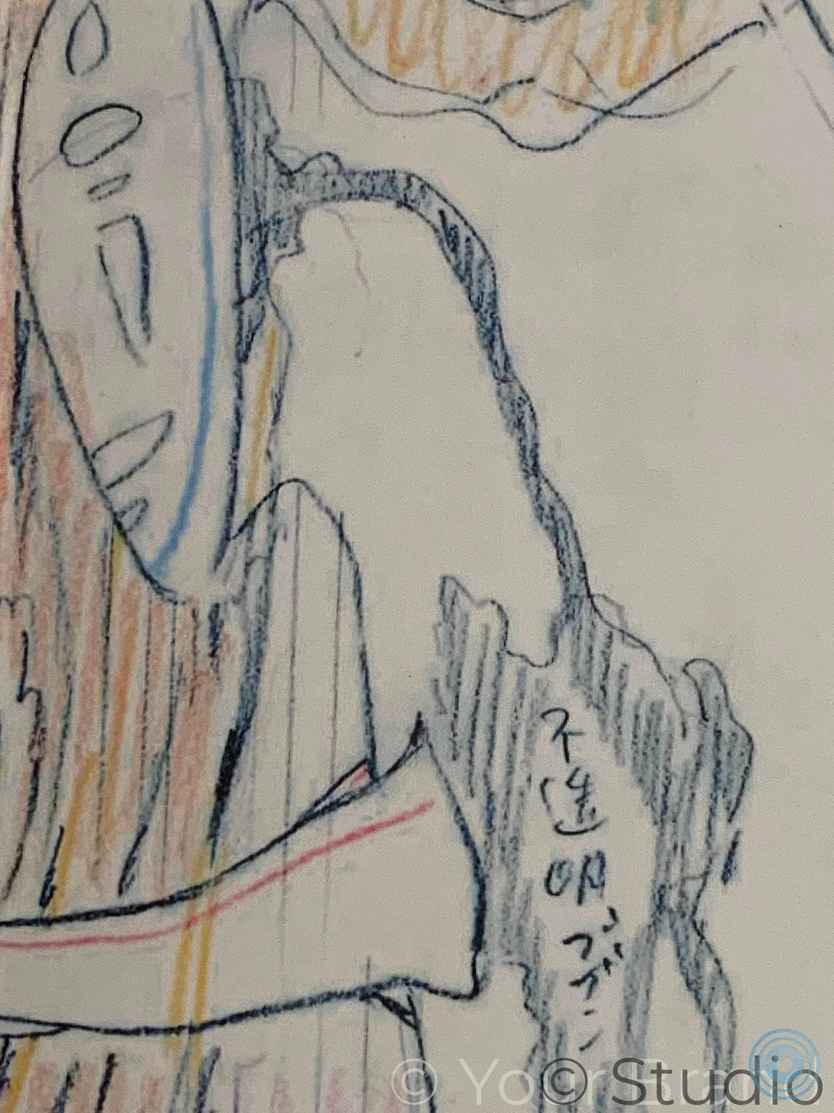 A close-up of a coloured pencil drawing on textured paper, showing a figure in profile with blue, orange, and black sketch lines and Japanese characters written on a rock. Spirited Away movie poster