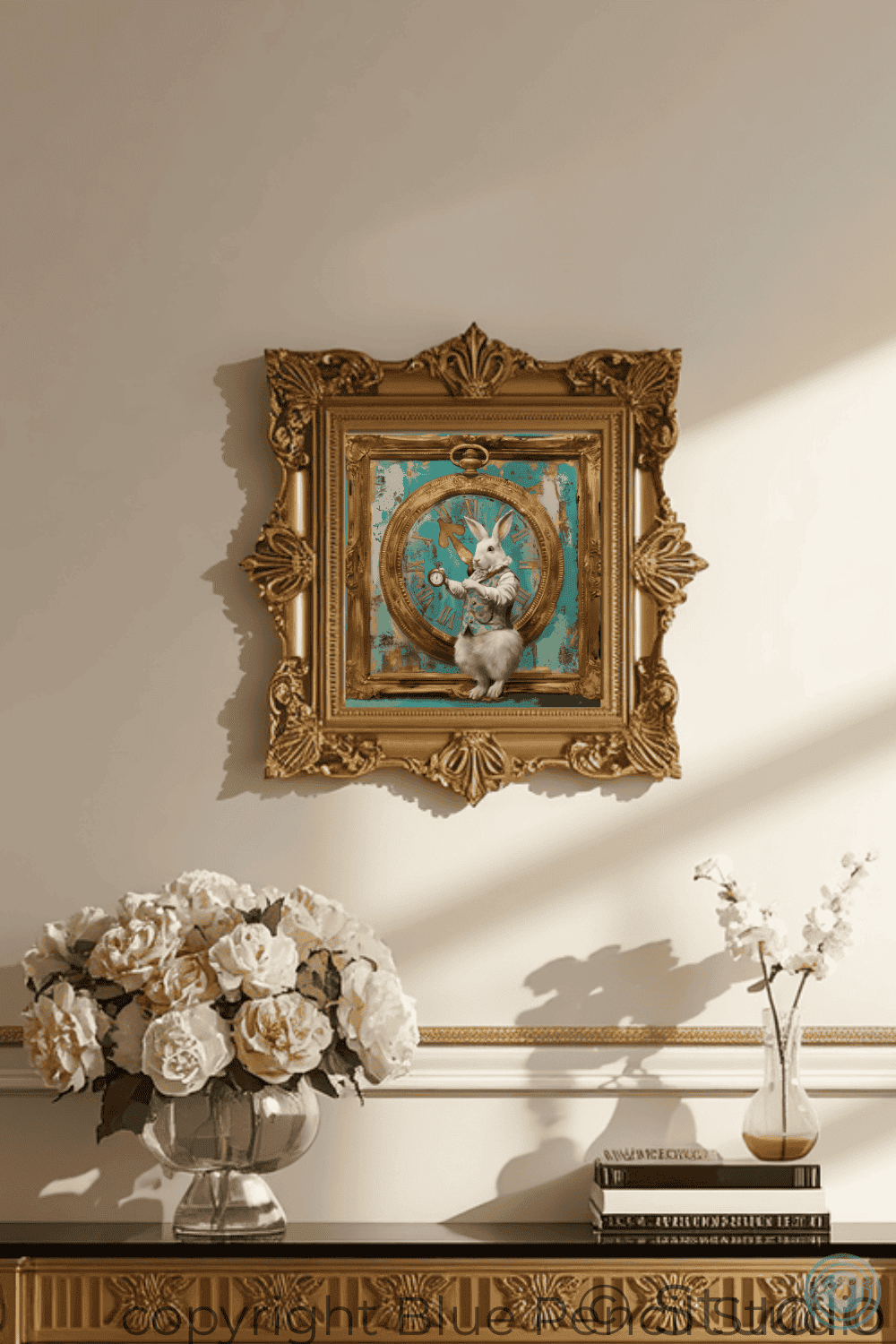 An ornate gold-framed painting hanging on a beige wall above a console table. The painting depicts a white rabbit inside a circular frame against a turquoise background.
